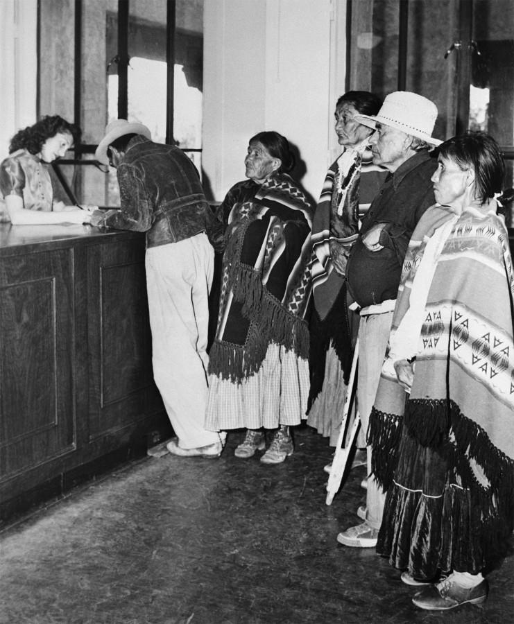 Waiting to register to vote, several Native Americans stand in line after the news of the Voting Rights Act passing reached them. Voting has always been a huge issue in the Native American community due in large part to the constant turmoil in the status of citizenship.