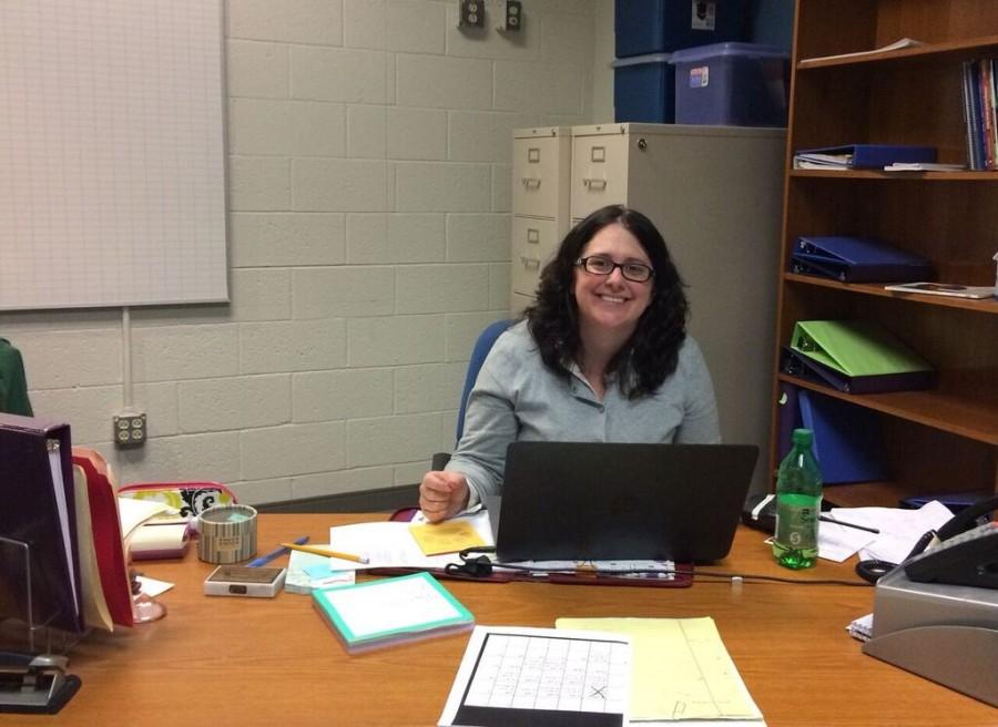 Posing for a picture at her desk, Ms. Drouhard takes a quick break as she prepares to leave for her departure. Her involvement in multiple programs at Millbrook keeps her busy all the time and makes every day a new adventure, which is why she will miss Millbrook, and MHS will miss her.