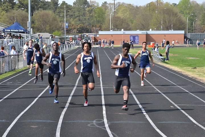 Running to the finish line, Mateo Levarity, Isaiah Bowman, and Andre Freeman push each other to be better. Teams that make each other better excel as Millbrook placed second in the state championship meet last year.