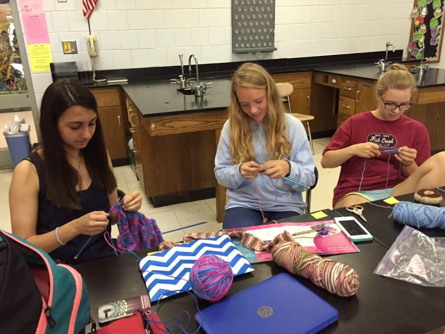 Knitting a hat for for the Heavenly Hugs Hat Ministries, president of the Knitting Club, sophomore Alexandra Butler, also teaches freshman Brooke Finnessy and junior Liz Finnessy how to become better knitters. The  Knitting Club is for anyone no matter how experienced of a knitter you are!