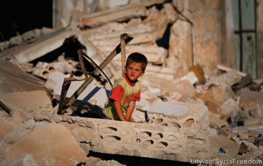 Standing in the ruins of his family home, a Syrian child becomes one of the tens of thousands of Syrians left homeless around the country as a result of the war.  Ruins like this are the result of airstrikes, similar to the ones on Aleppo.
