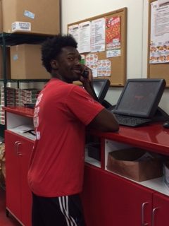 Working hard, senior Alex English answers phones at Jet’s Pizza. Alex has been lucky to find a job opening in the Raleigh area, unlike many others.