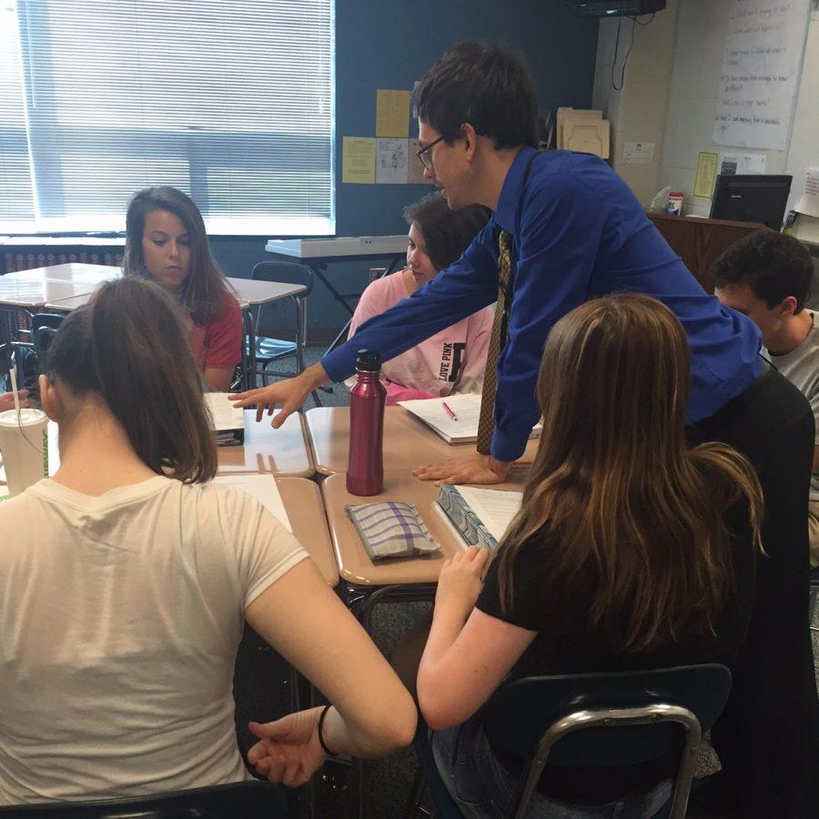 While teaching his IB Language and Literature class, new teacher Bradley Samore is hands-on in helping students understand the lesson. Mr. Samore strives to provide a guided style of teaching for his students