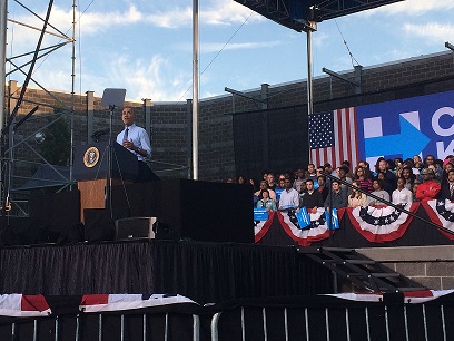 Speaking in front of his crowd in Greensboro, President Obama addresses the audience on social issues such as our economic system. President Obama travelled around the country to help support the Hillary Clinton campaign.
