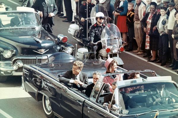 Taken just minutes before his assassination, President Kennedy rides through the Dealey Plaza with his wife. Conspiracies surrounding Kennedy’s death have been around for nearly 50 years.