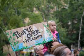 Protesting at Standing Rock, this little girl holds up sign in support of the Sioux tribe. People of all races, genders, and different Native American tribes have gathered to protest the pipeline.