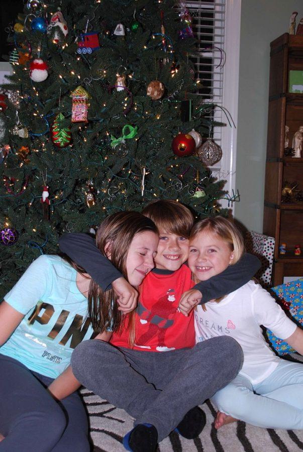 Enjoying each others company in front of the Christmas tree; Grayson McClendon, on the left, and her family have their own unique way of celebrating Christmas. With so many different customs and traditions, Christmas is a truly secular holiday.