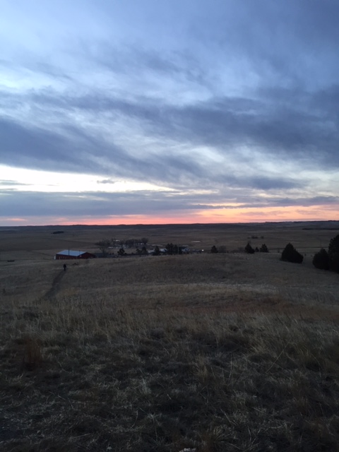 Standing on top of a hill, Jessica Tomlinson catches the gorgeous sunset on the reservation. Rolling hills go on for as far as the eye can see on the Pine Ridge Indian Reservation.  

