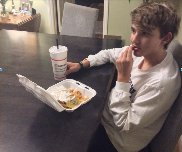 Enjoying his food, freshman Noah Marshall eats a meal from Cookout. Eating meals like this everyday can cause health problems for teens.