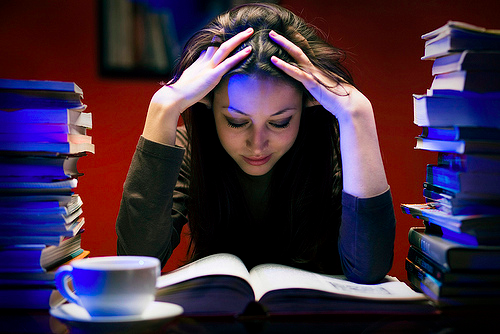 Overwhelmed by her studies, this teen pounds her coffee for a late night study session. Teenagers today face extreme amounts of stress on a daily basis which is leading to many health concerns.
