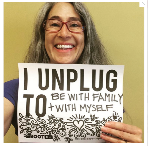 Holding a sign to represent the National Day of Unplugging, Aliza Sherman says she unplugs to be with her family and herself. The National Day of Unplugging aims to turn of electronics and relax, reconnect, and go outdoors.
