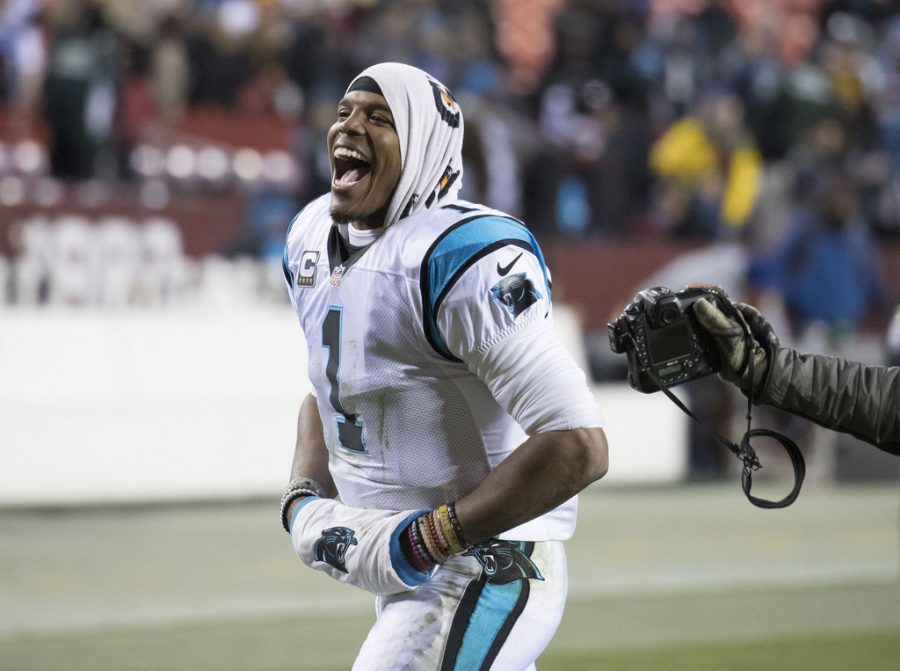 Celebrating an epic win, Cam Newton cheers with his team. Although the glory days for Cam are still not over, numerous disheartened fans and reporters are criticizing his sexiest comment that discriminates against female reporters. 