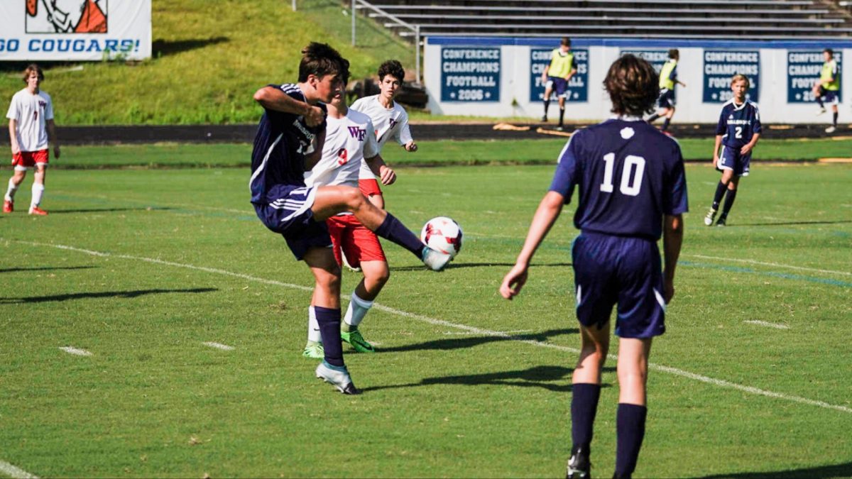 Warding off the defender, Ryan Rebne passes the ball to a teammate. Playin soccer is one of many things Ryan enjoys doing here at Millbrook. 