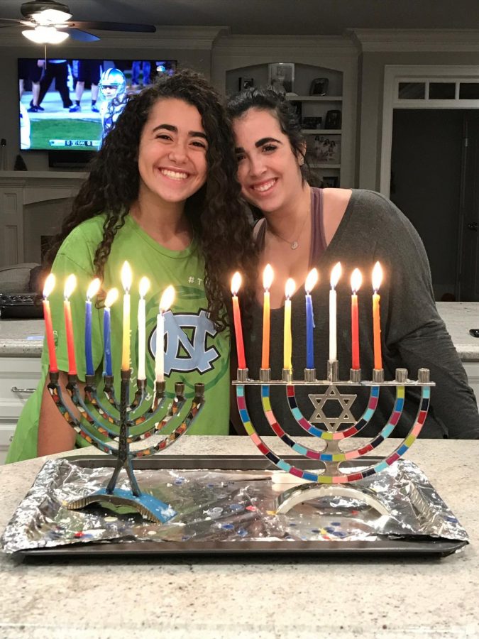 Gathered around their menorahs, Jamie and Sydney Horwitz just completed lighting their 7th candle. Lighting menorahs is a popular tradition of Hanukkah, originating from 168 B.C.E. 