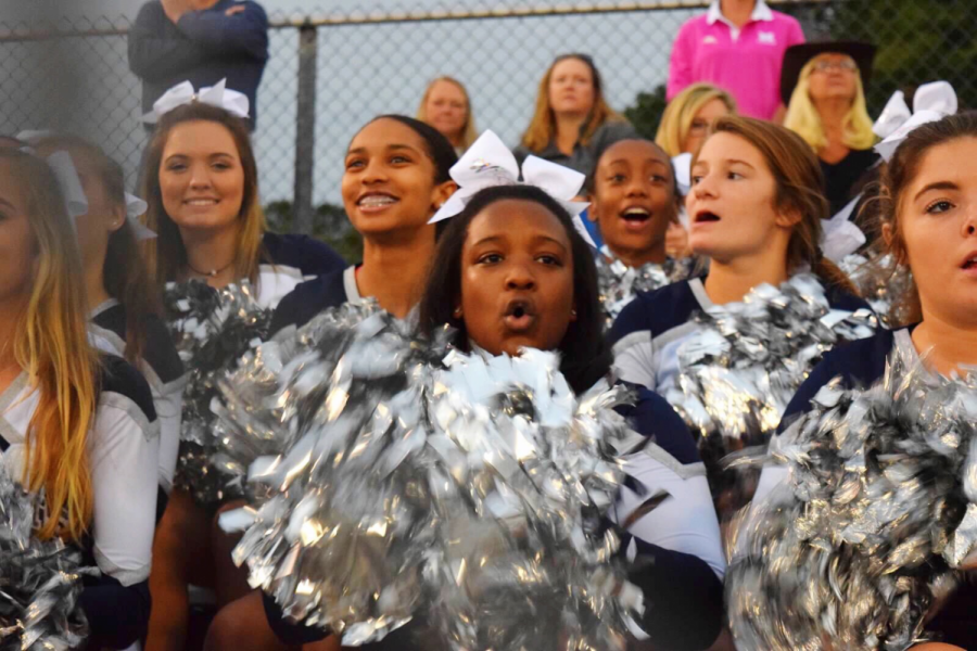 Leading+the+crowd+at+a+football+game%2C+Bria+Bryant+cheers+on+her+team+with+the+other+varsity+cheerleaders.+This+is+just+one+of+many+ways+Bria+shows+her+school+spirit+at+Millbrook.