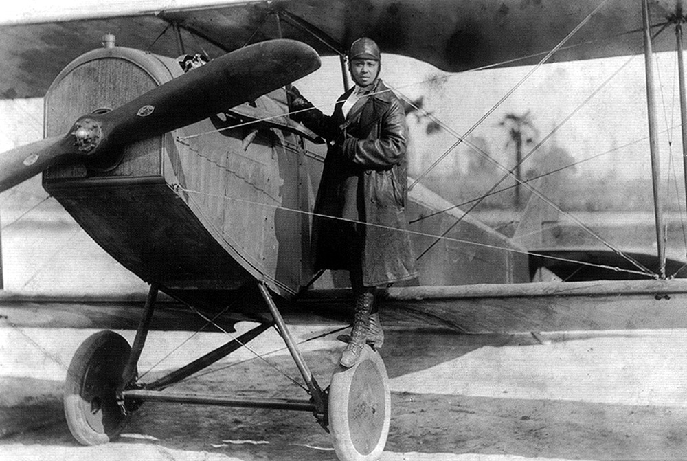 Preparing to take flight, pilot Bessie Coleman is about to climb into the pilot’s seat. As the first Black American female pilot, Bessie was an inspiration for many women of color.