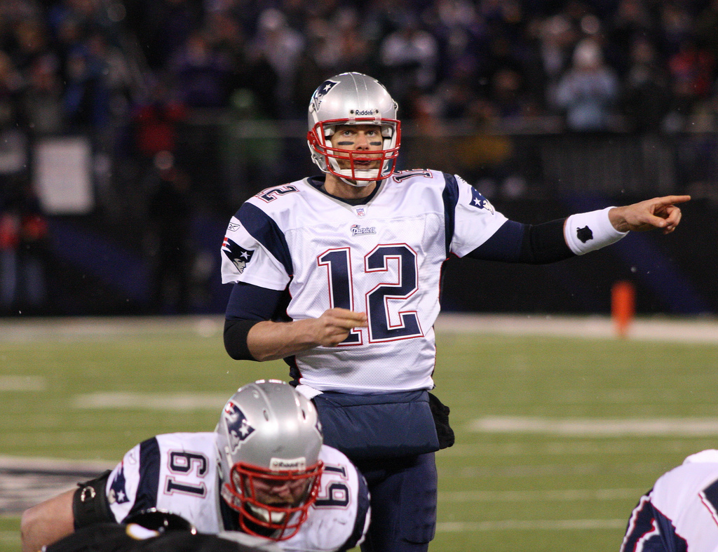 Battling through a tough game, Patriots quarterback Tom Brady calls for a play in order to deliver a complete pass. Brady received the NFL MVP award for the third time on Saturday after having lead his team to a successful 13-3 season and another appearance in the Super Bowl.