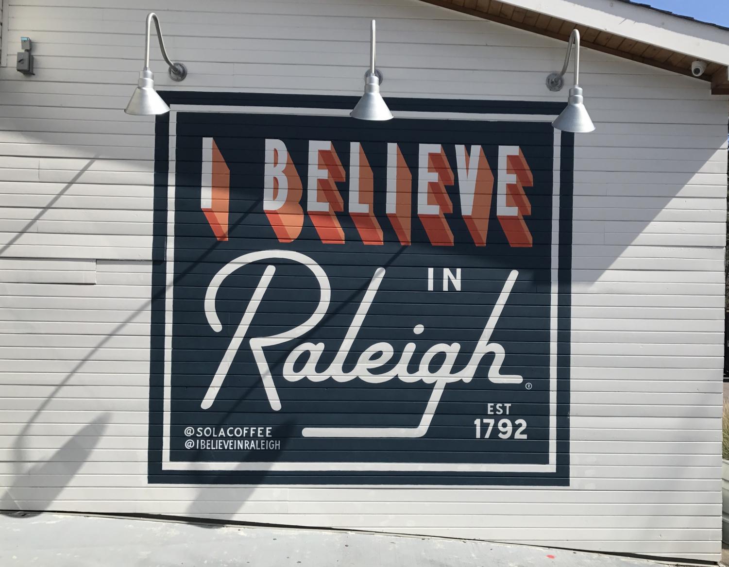 Representing the I Believe in Raleigh movement, the mural is painted across the back of the picturesque Sola Coffee Café. Sola is the perfect place for anyone looking for a cozy, laid-back dining experience and a taste of some of the best food in Raleigh.
