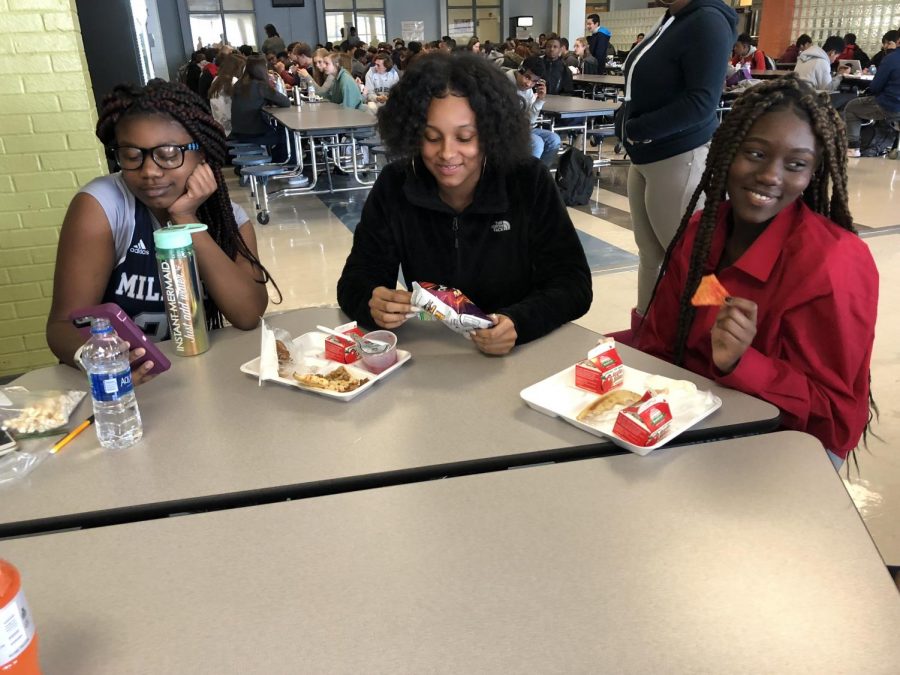 Trying to eat nutritious lunches in the cafeteria, students TreShure Williams, Aaliyah Maye and Yasmine Kapini eat pizza and fruit to try to maintain a healthy balance of the food groups. March is National Nutrition Month, and it is important to know how to make healthy choices when eating lunch on and off campus.