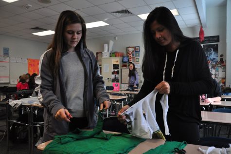 Working hard, club secretary Sara Vandersip and club service committee member  Kaylee Zuniga make dog toys out of old t-shirts to donate to the SPCA. The Key Club is a service oriented club focused to giving back to the community through different service projects.
