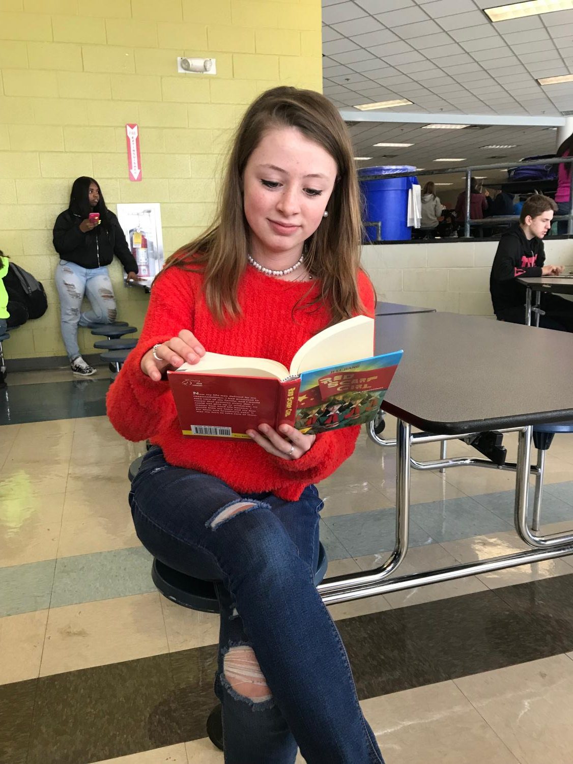 Reading a paperback book, Lily Morrow sits in the cafeteria oblivious to the world around her and absorbed with the story she is reading. This is just one example of how books and reading can impact our lives.
