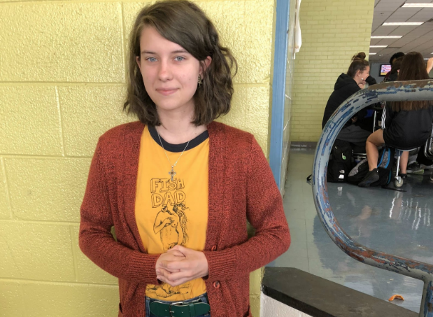 Smirking for the camera, junior Eli McCarthy dons her favorite graphic band t-shirt. Graphic tees were among the many favorite fashion trends worn by Millbrook students this year.