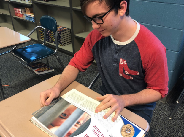 Taking detailed notes, sophomore Jake Seagraves reads off of a lengthy textbook. In our modern world, with all our new technology, the value of textbooks is being questioned.