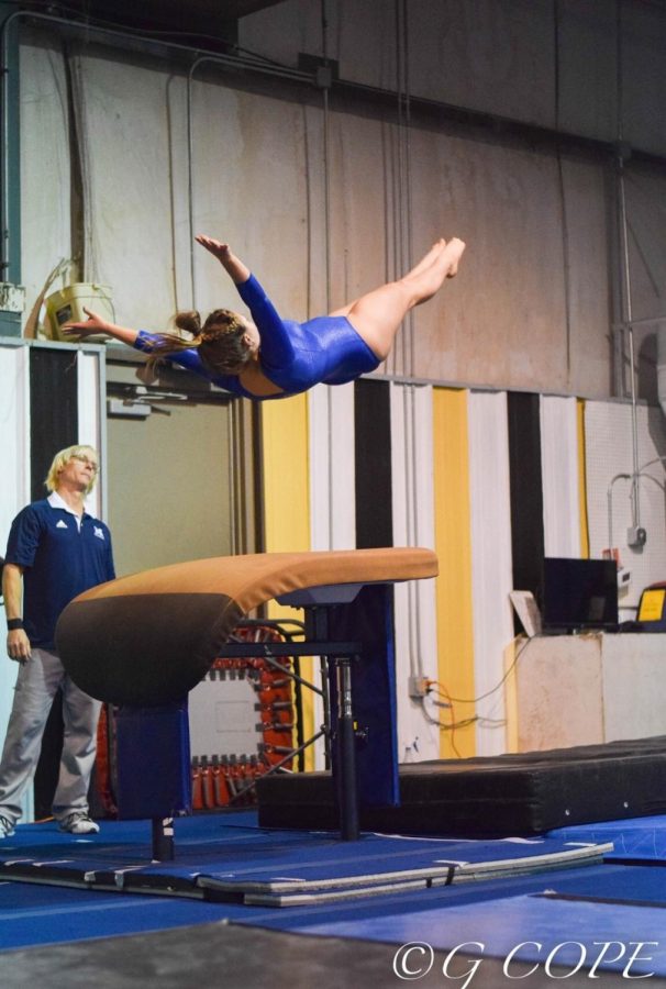 Thrusting herself into the air, senior Andrea Shealey executes a challenging vault routine. As captain, she commends her teammates for their enthusiasm and support of one another. 