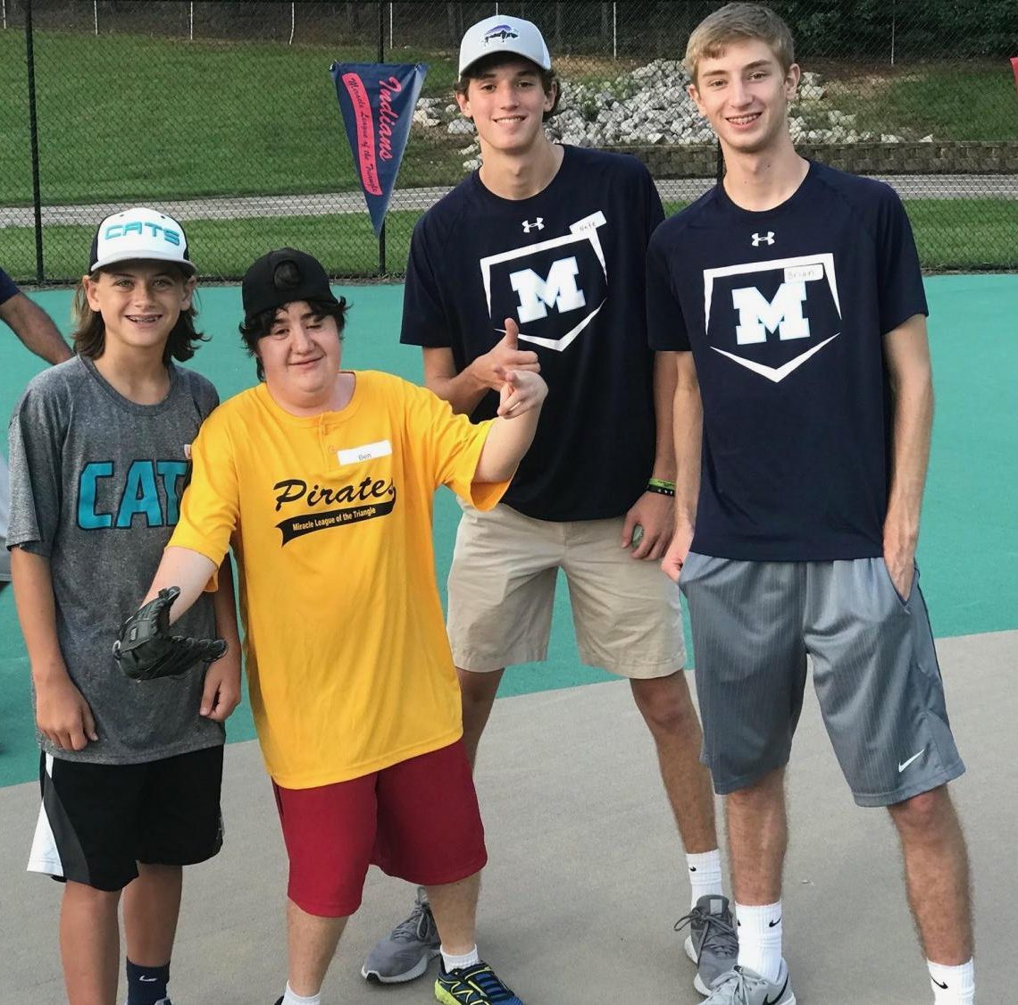 Posing for the camera, Millbrook freshman Witt McClendon, sophomore Nate Johnson, and senior Brian Pearce celebrate their new friend Ben’s first home run at the Miracle League Game. Aside from playing baseball, Ben loves to dance and listen to rock and roll music. 