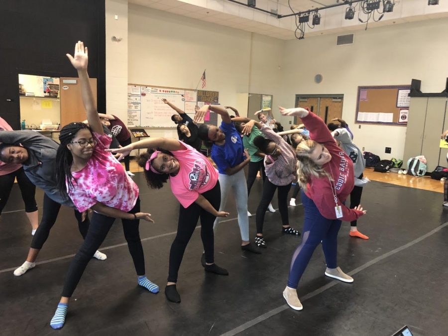 Leading the class in a warm up, Ms. Hoy stands at the front of the class to prepare her students for a great day of dance. Helping people and dance are her two favorite things, so what better than to be a dance instructor!