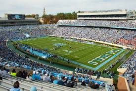 Cheering on their UNC Tar Heels, Chapel Hill students show their school pride with bright shirts and accessories. The University has changed the meaning behind stadium name because of the racist tendencies of the man that was memorialized by it.
