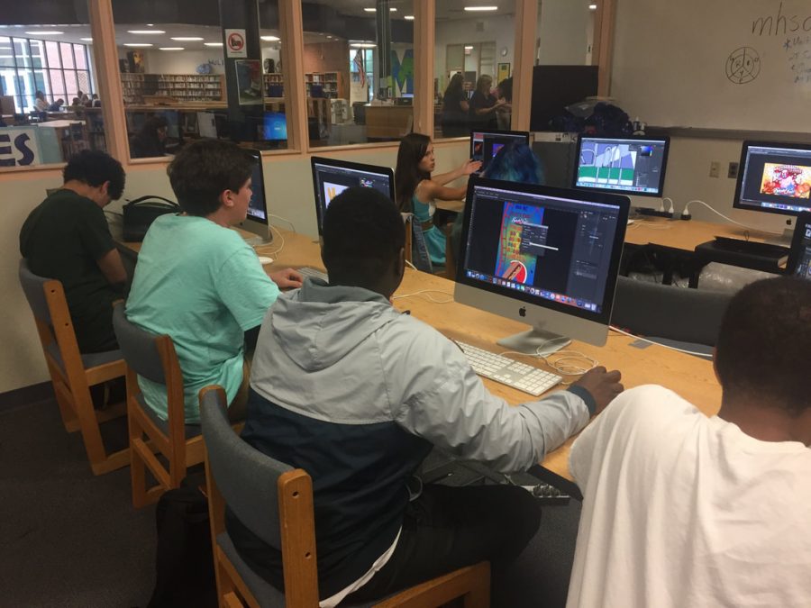 Working diligently on their graphic design project, the DMCA students work to improve their skills. The DMCA offers participating students many classes throughout their high school career to help learn new and useful skills to be utilized  in the professional world.   