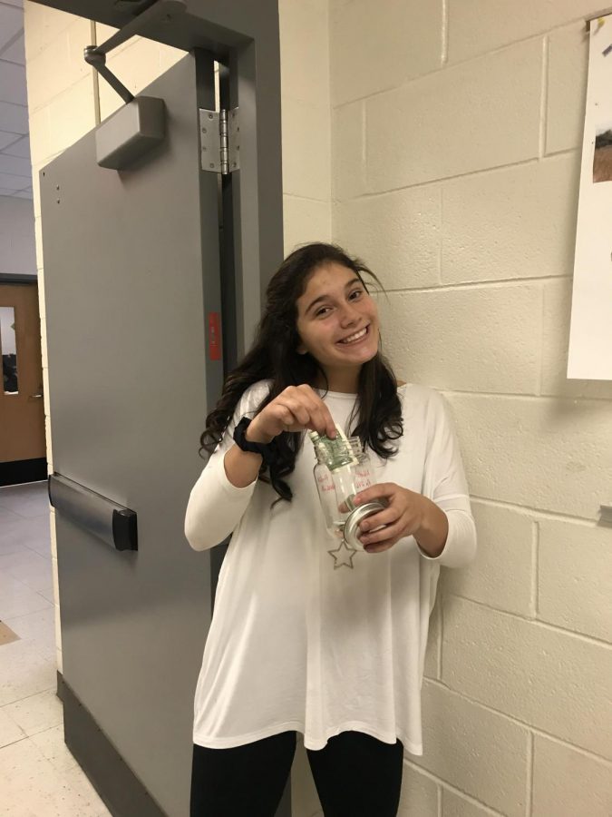 Donating can help many people. Sophomore Jessica Miller drops her money in a food drive collection jar to help out the millions affected by hunger. Donating is a great way to help in your community because you can help someone out even if you do not have extra time.