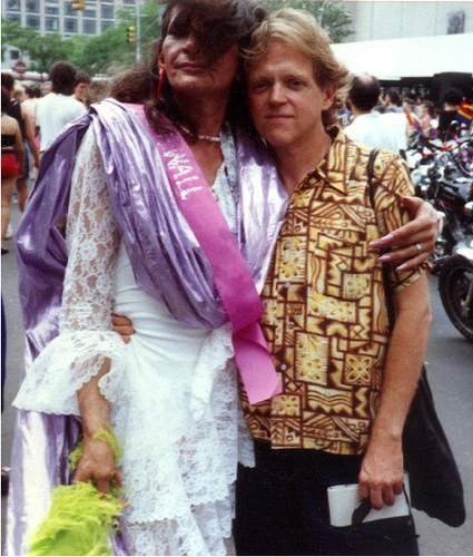 Posing with Jim Fouratt (right), Sylvia Rivera celebrates at a Pride March in 1977. Although she was typically not welcome to these events, Rivera would attend anyways to push barriers in the community.