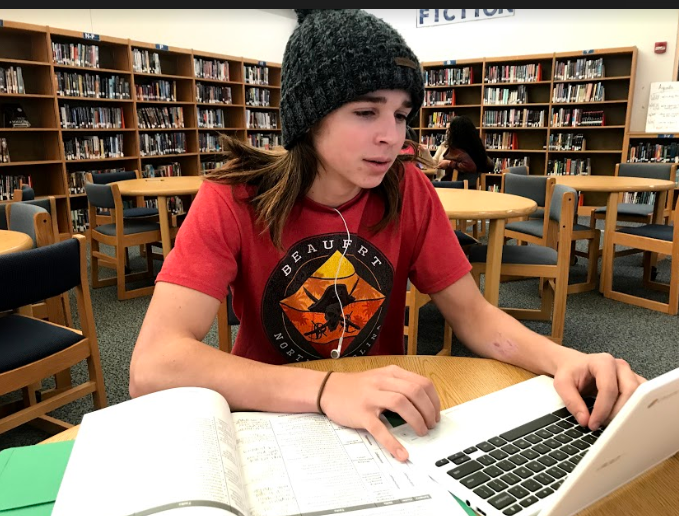 Sitting in the library, sophomore Evan Smith works on his personal project paper during lunch. By using ones time wisely and efficiently, you can get more things done in a shorter amount of time. 
