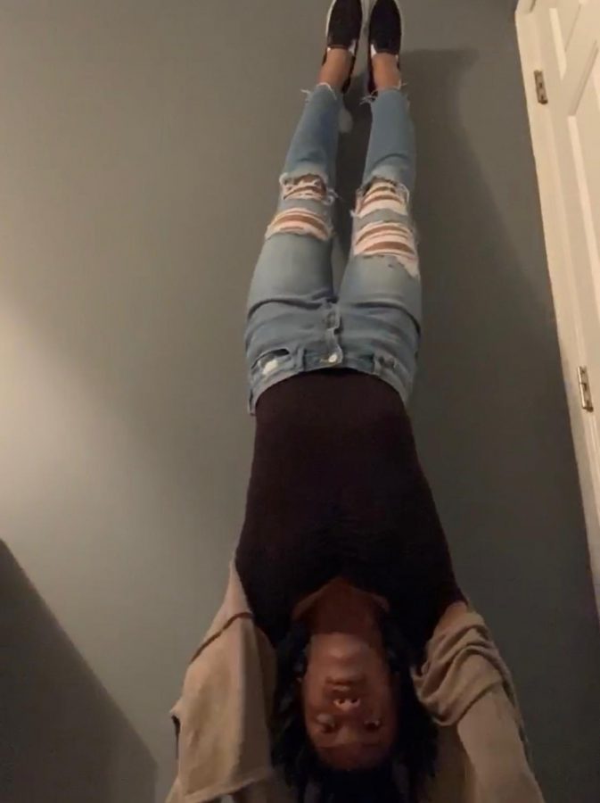 Doing a handstand, junior Aliya Ward has hopes of getting rid of her hiccups. This is just one of many things that we can do to get rid of those awful things!