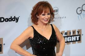  Posing for the red carpet cameras, the famous Reba McEntire attends yet another award show. This year she hosted the 54th Academy of Country Music Award show for her sixteenth time; she stated last night that she will never get tired of celebrating great music and amazing stars.