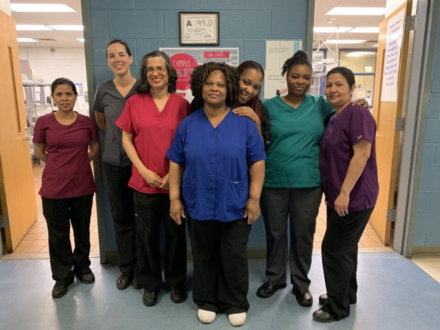 Grinning widely, Holli Blackwell and her staff stand proudly in front of their 99.0 sanitation rating. They work hard to make certain that each student has received the best possible experience dining in the cafeteria.