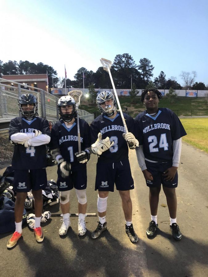 Freshman and sophomore JV Lacrosse players Jahmari Smith, Logan Massey, Parker Shoun, and Uchenna Onyebuchi pose after a picture following a game. Building great friendships is a major perk of school sports! 