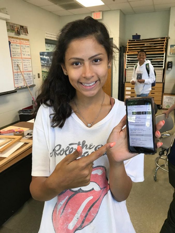 Pointing at her Common Application account, Senior Kaylee Zuniga hides her college stress behind a smile. Although planning for college can be stressful, Kaylee took the steps that were necessary for her success throughout high school so that she can be confident in her application now. 