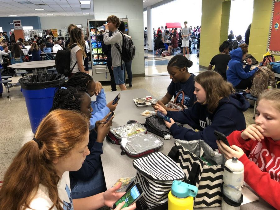 Playing on their phones, Millbrook freshman Hannah Rose Morrow, Mary Katherine Boone, among many others catch up on social media during their lunchtime. As much fun as phones are, they can also be blocking teens from doing schoolwork, chores, and interacting with others, therefore lowering their overall work ethic and motivation for everyday tasks. 