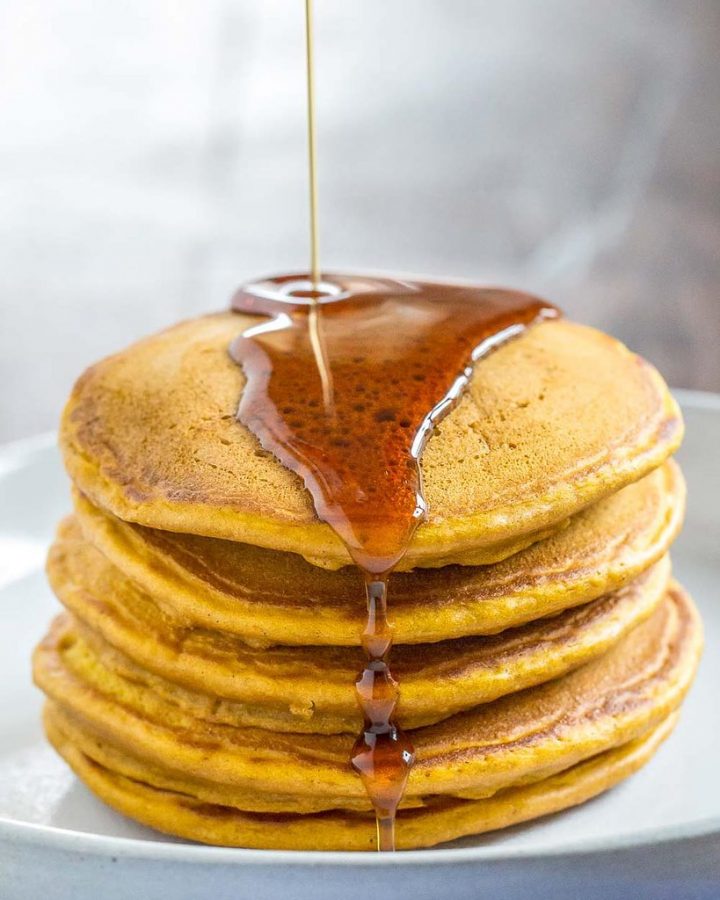 Layered in a neat stack and topped with syrup, these pumpkin pancakes are a delicious treat to have for breakfast. Pumpkin puree is a perfect addition to add to a pancake recipe for added flavor, nutrition, and a lovely orange hue.
