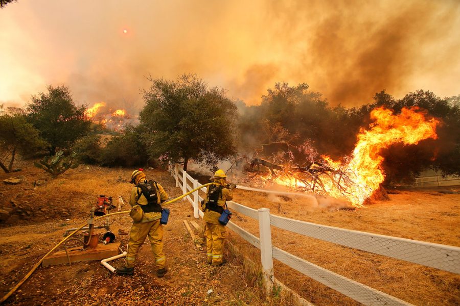 Dowsing water into the air, these firefighters in Stockton, California attempt to prevent a wildfire from diverting towards people and property. Extreme weather such as fires and hurricanes have become more frequent in recent years partly due to changes in the environment.  
