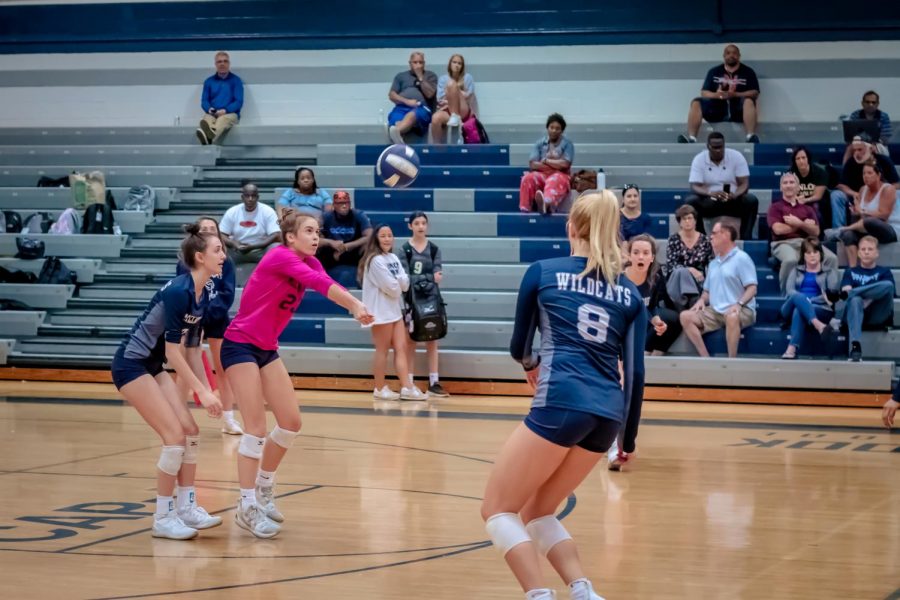 Showcasing her athletic determination, freshman Kate Kilpatrick passes the ball to her teammates in hopes of scoring a point. She put in a lot of work to make the Varsity team and is eager to compete at the highest level all while proving herself to her teammates. 