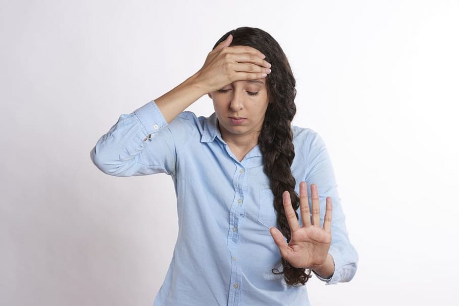 Holding up her hand, this headache sufferer signals to others to give her space as her headaches grow more agonizing. The symptoms caused by headaches make those individuals less likely to focus, concentrate, and respond in class because of the debilitating pain.

