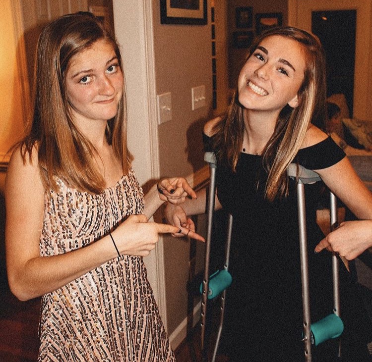 Pointing at her crutches, Mati Roberts displays a positive attitude despite the challenge she has been confronted with. The presence of her friend, Caroline White, reminds her of the amazing friends and family she has to support her as she makes her comeback.