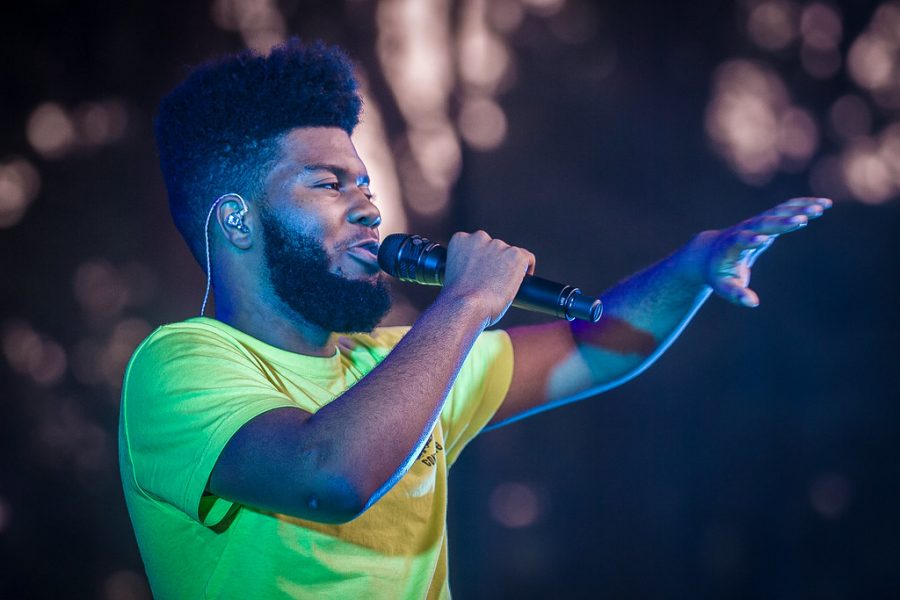 Performing at a concert, Khalid sings in front of the crowd. Khalid has created countless hit songs and was named one of the most influential people of 2019; his authenticity is something that he is respected for.