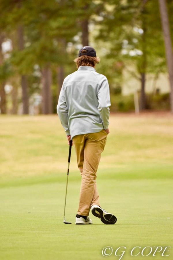 Gazing down the stretch of the course, senior Luke Nelson tries to spot his next hole. He has been a member of the men’s golf team for four years, and was the only senior on the team this past school season. 