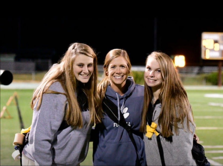 Working a varsity football game, junior Emma Harrison, Ms. Dawson, and junior Addison Dameron watch over the team to make sure every player is healthy and safe. This is just one of many things that sports med does for us here at Millbrook.