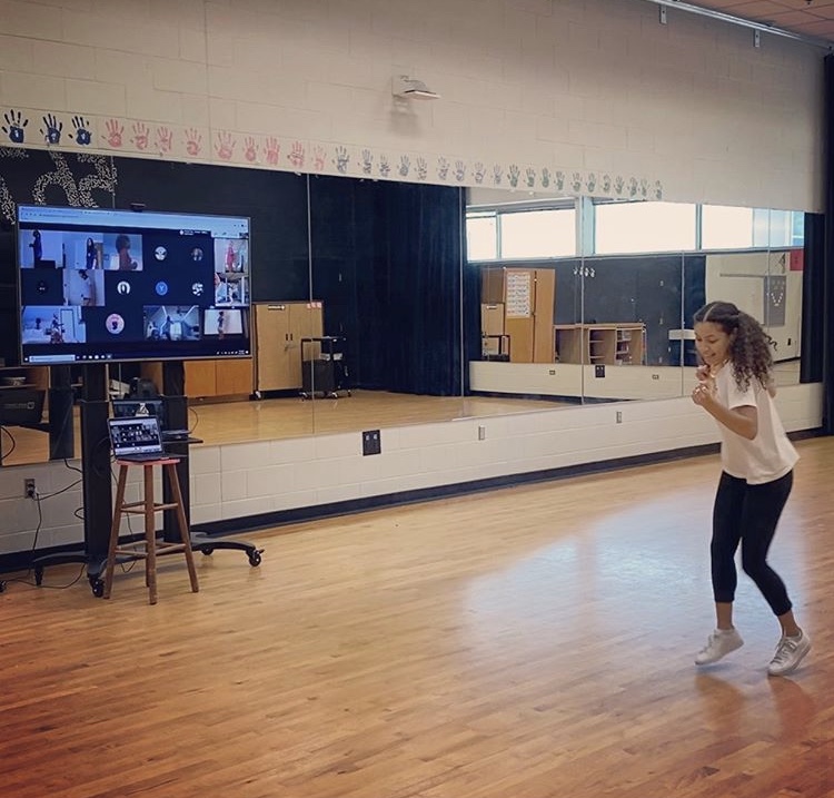 Dancing+alongside+her+students%2C+Ms.+Cruz+makes+the+best+of+remote+learning.+The+pandemic+has+definitely+changed+the+way+school+looks%2C+but+we+will+always+find+a+way+to+dance+together.+%0A